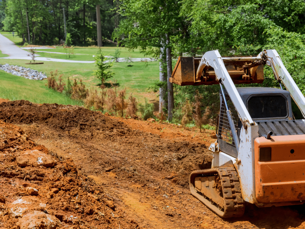 McCandless Plumbing & Excavation prepares land for work, leveling soil to get the site ready for construction or repairs.