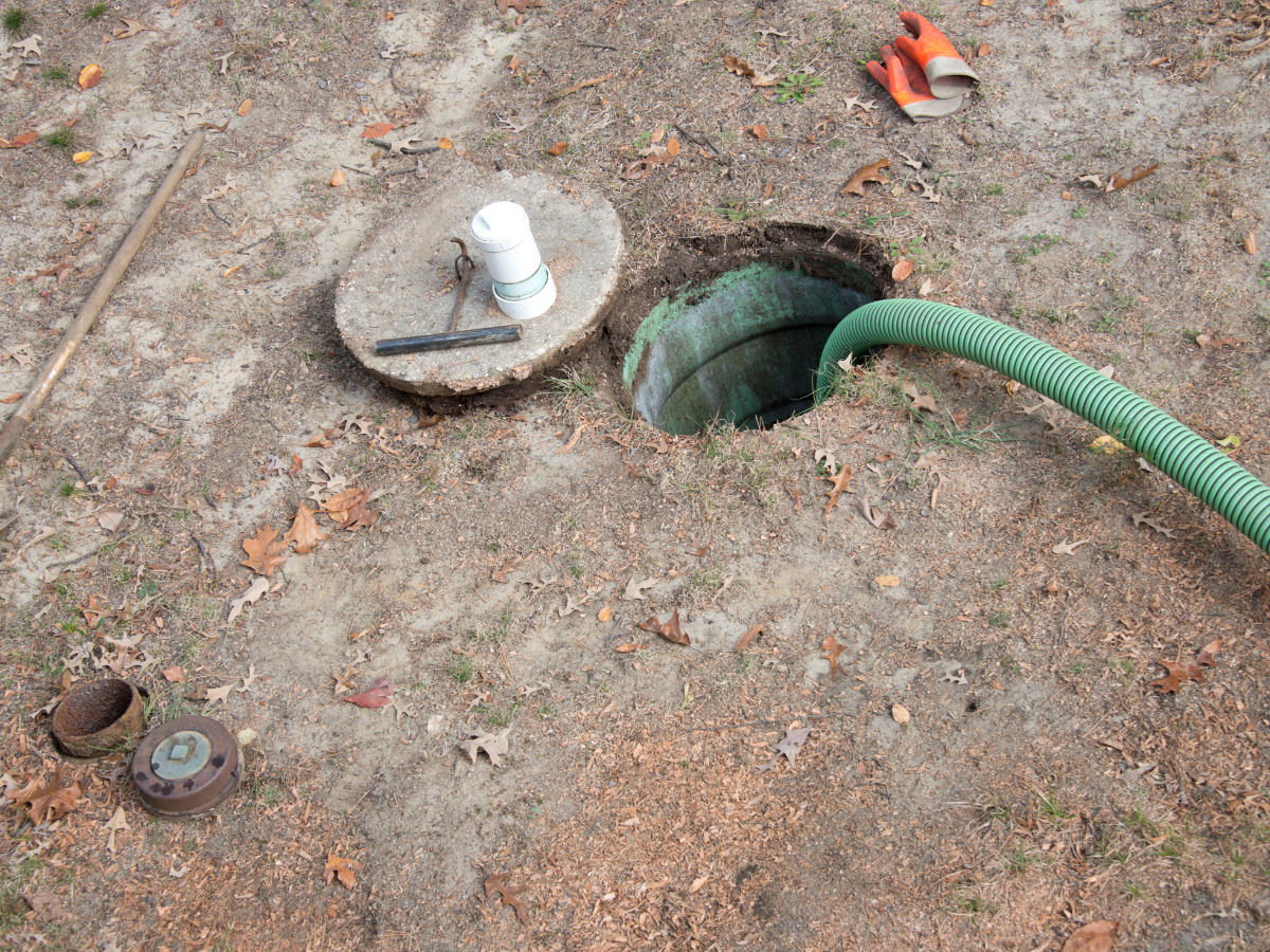 McCandless Plumbing & Excavation prepares for a septic system check with tools ready and safety precautions in place.