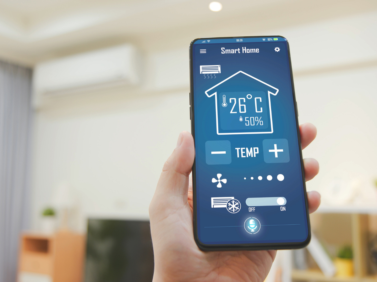 McCandless Plumbing & Excavation app shows home temperature, humidity, and sewer camera inspection controls on a phone screen.