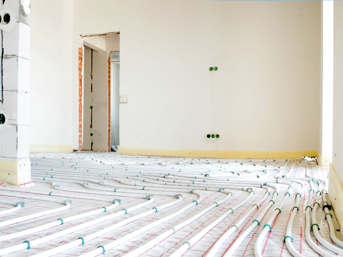 A home is being renovated, showing underfloor heating. This setup is helpful for McCandless Plumbing & Excavation repairs.