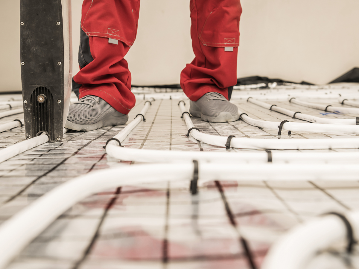 McCandless Plumbing & Excavation technician checks underfloor heating system to ensure proper function and safety.
