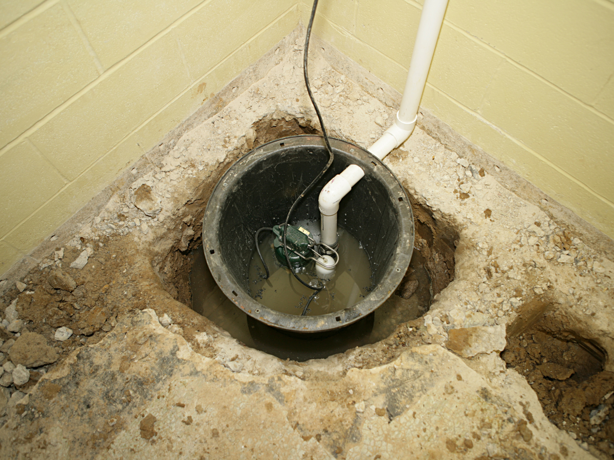McCandless Plumbing & Excavation sump pump setup showing typical inspection area in a basement for water control.
