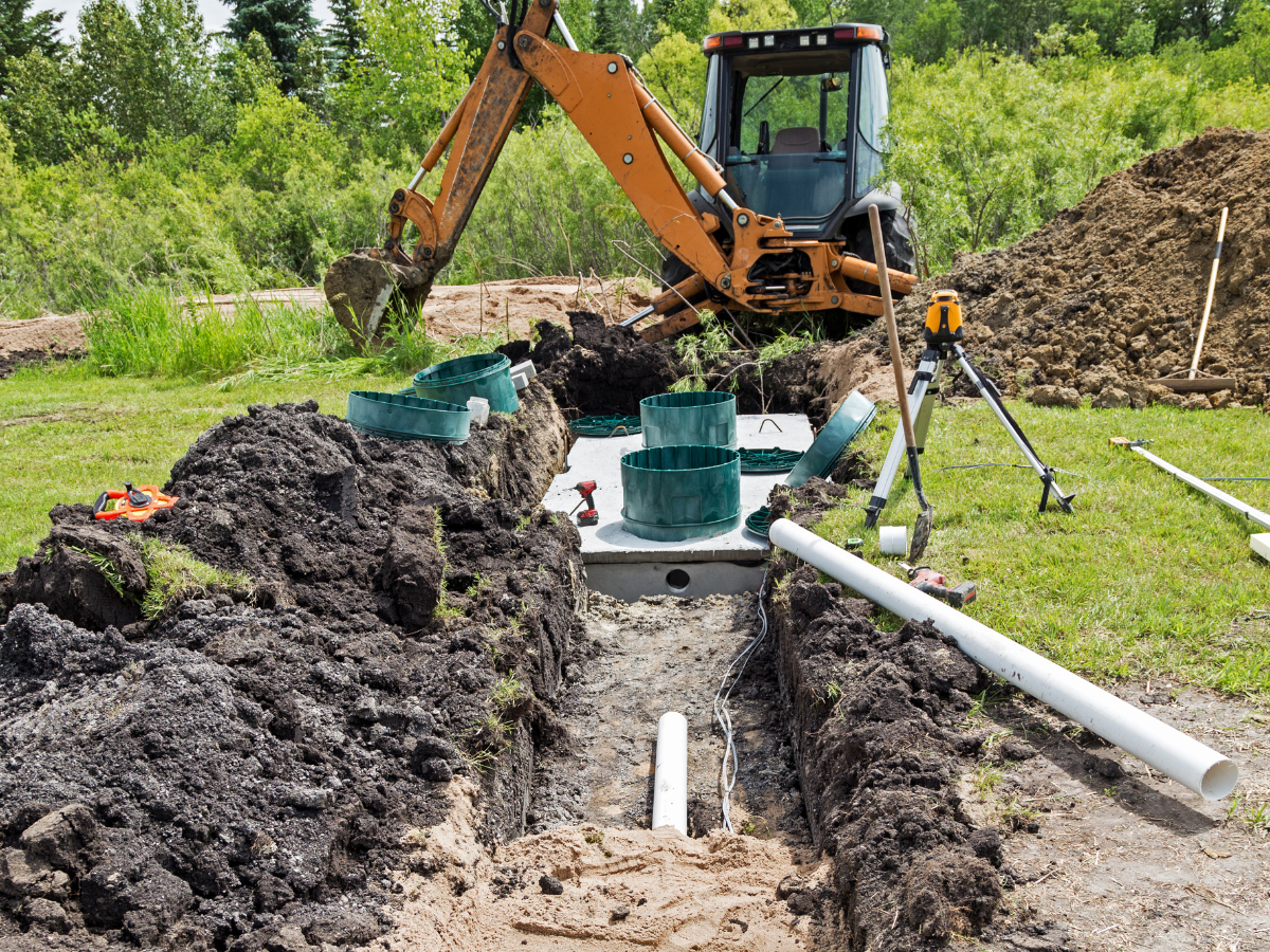 McCandless Plumbing & Excavation works on a rural septic system, preparing for inspection and cleaning services.