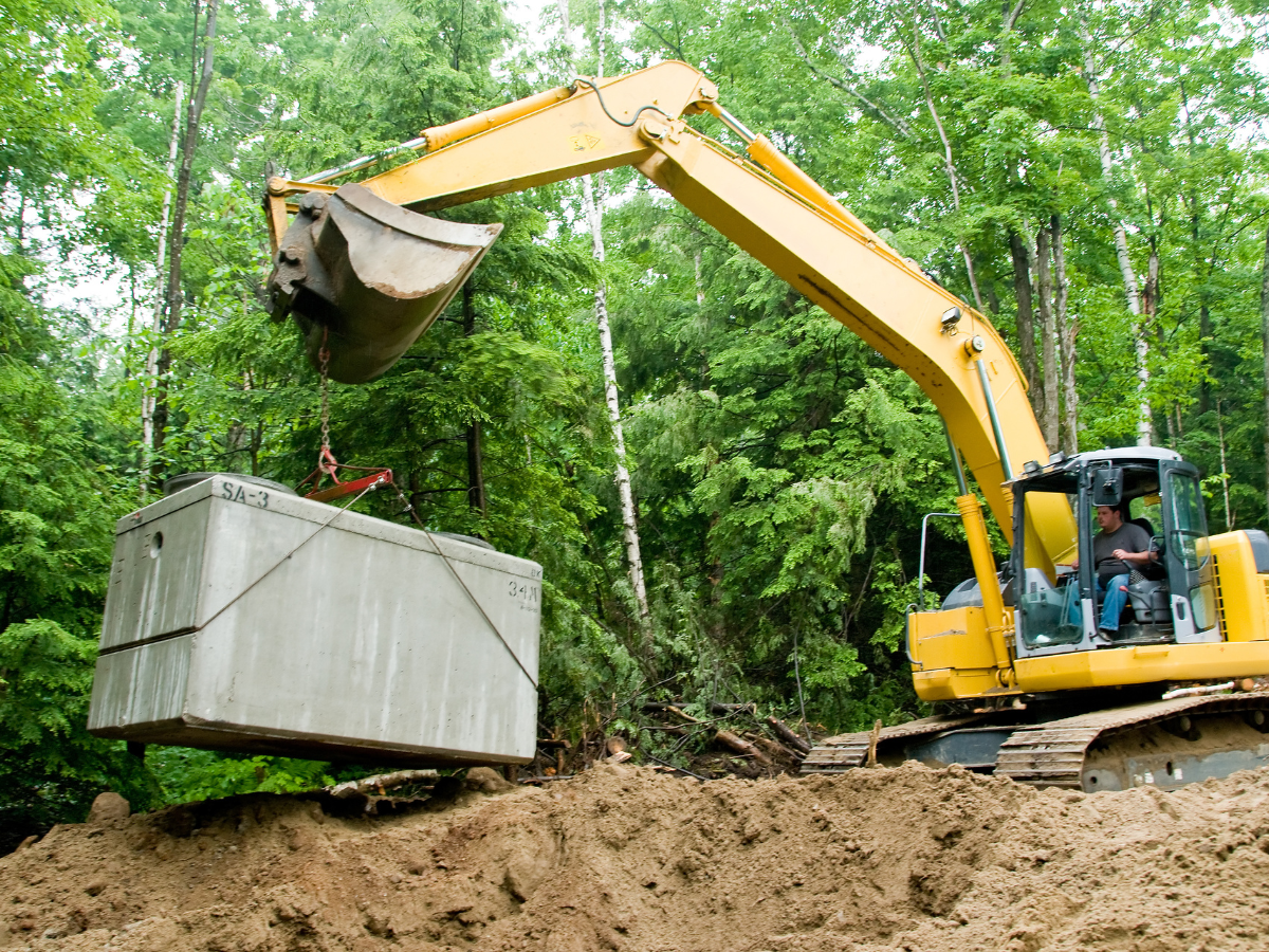 McCandless Plumbing & Excavation safely moves heavy materials at a job site, showing their skill and attention to safety.