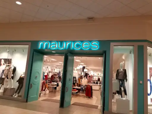 A mall clothing store sits brightly near McCandless Plumbing & Excavation, a shop for sewer repair and plumbing services.