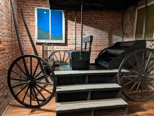 McCandless Plumbing & Excavation offers expert excavation, shown by an old-time carriage and a sign at their business.