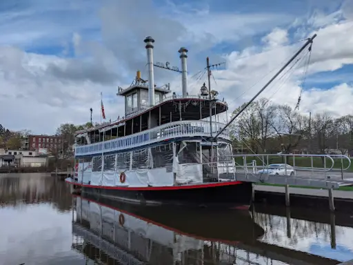 A riverboat is docked by McCandless Plumbing & Excavation, which offers septic system inspection nearby the waterfront.