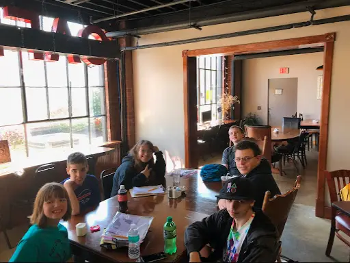 Friends gather at McCandless Plumbing & Excavation, happily sharing stories like learning about sewer camera inspection.