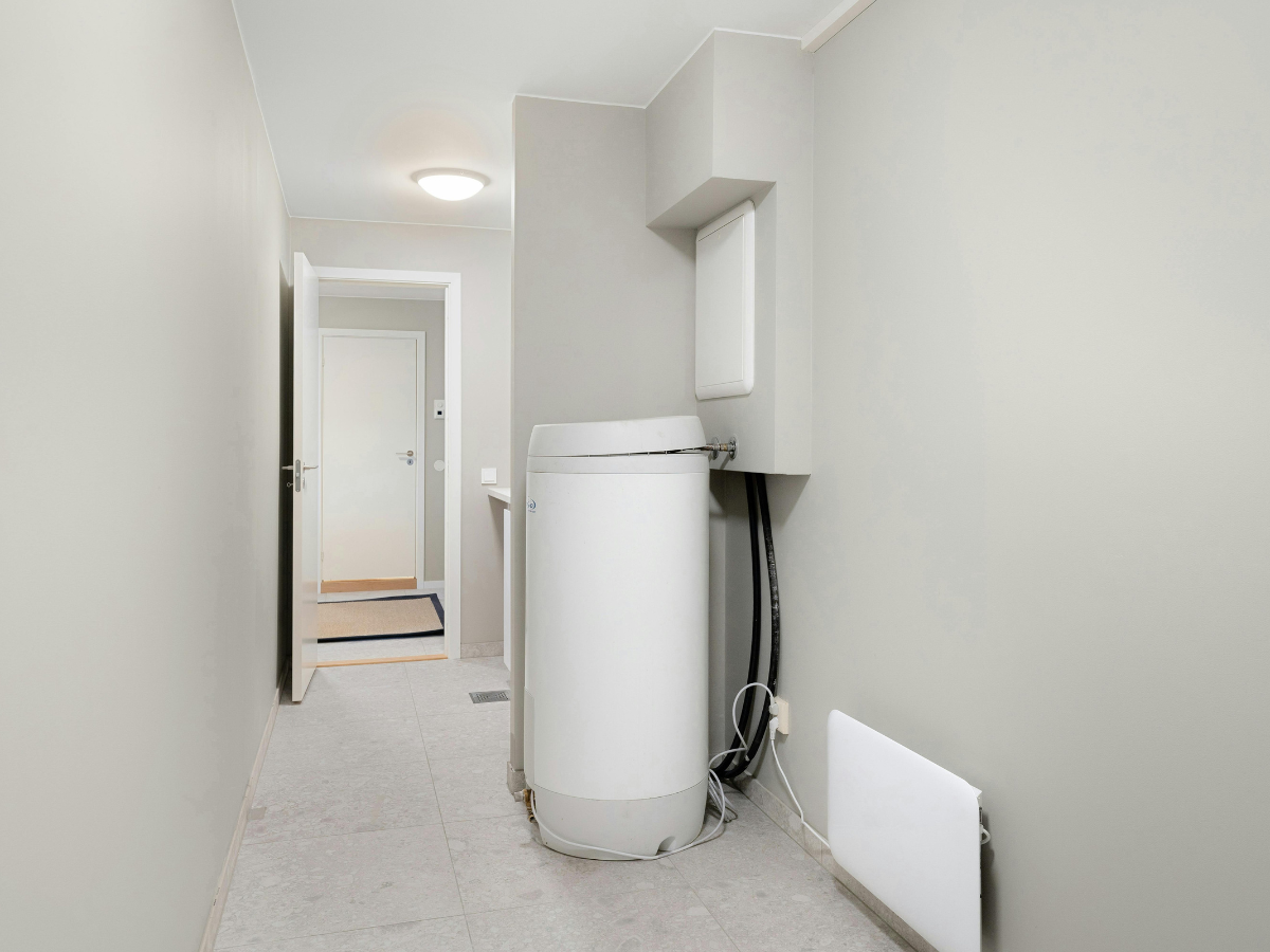 McCandless Plumbing & Excavation provides easy access to water heaters for septic inspections in a simple, clean space.