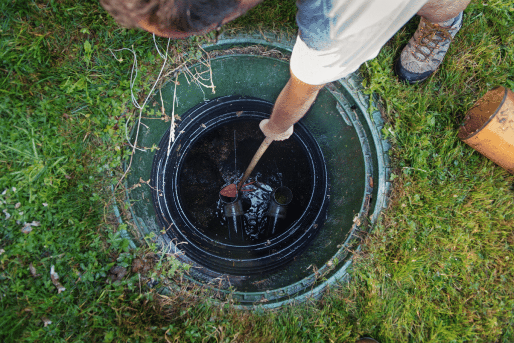 McCandless Plumbing & Excavation staff checks or cleans a septic system, ensuring it's working properly for homeowners.